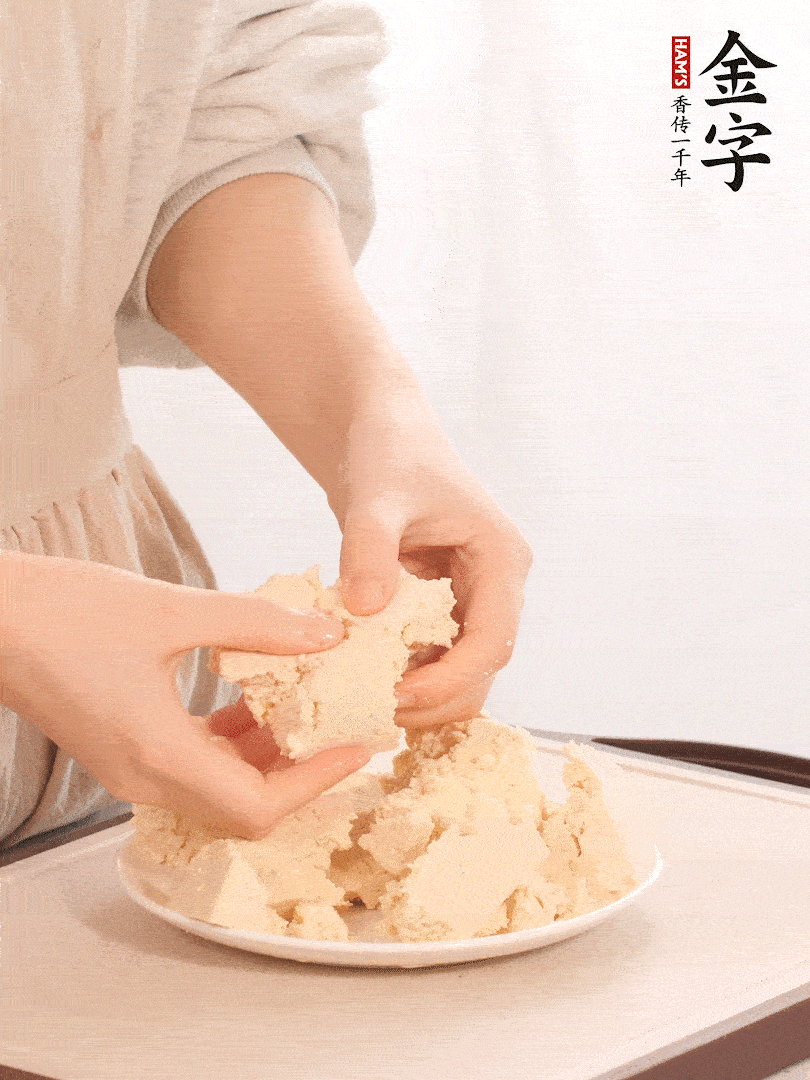 老豆腐用手掰成塊。