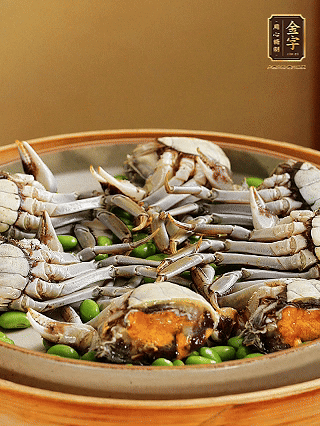 盤底鋪毛豆，依次放大閘蟹、咸肉， 淋一圈料酒、豉油。